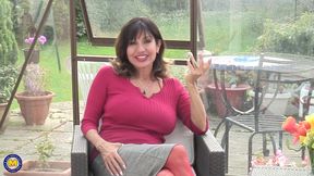 Busty mature smokes a cigar and plays with her pussy
