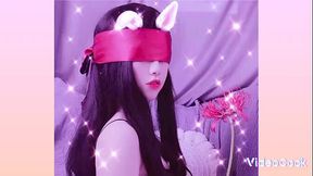 Asian girl bound by a scarf in BDSM scene