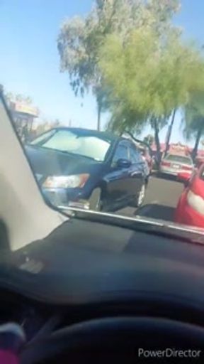 Mature woman pissing peeing in a public carwash parking lot
