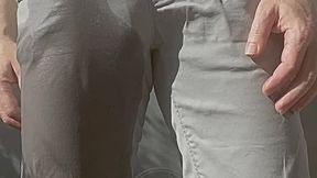 Jules wets his grey pants and exposes his semi-hard cock through his trousers