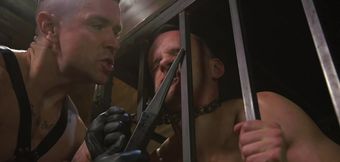 Caged male slave obeys his master's sexual desires