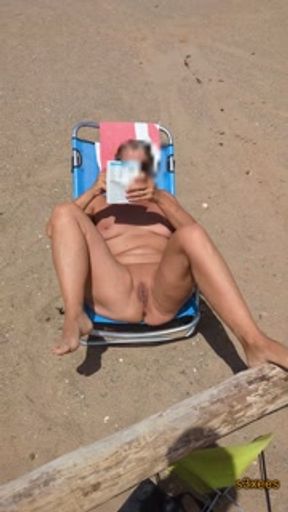 Exhibition on the beach. She tans her pussy. Cap d'Agde