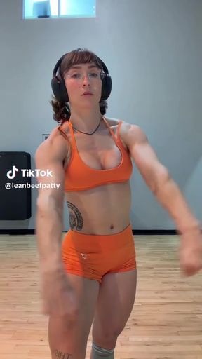 Female bodybuilder in orange sports bra