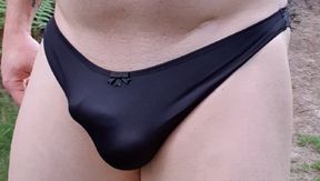 Smooth pantyboy walking around a forest and masturbating