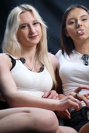 Two Girls Relaxing Together Sharing Cigarettes and Laughing in a Cozy Studio Scene