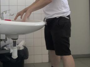 Guy Taking a Urine Sample in Hospital Toilets