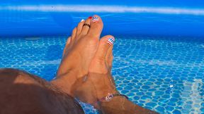 Floating in the pool showing some toes and my shriveled-up cock