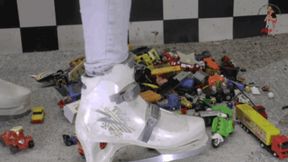 Toy cars and toy stuff under ice skating shoes