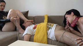 Anna dominates two slaves, makes one kiss her feet and the other give a blowjob