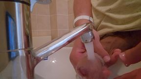 He washes his huge hairy cock and wiggles into the sink