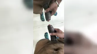 Horny twink strokes his big black cock in public bathroom mirror