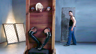 Bridgette B is put into the pillory and gets her both holes fingered