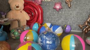sit on beachball and poping balloons