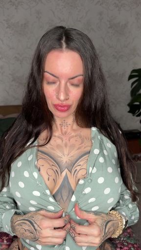 Tattooed woman in polka dot shirt