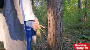 I pee outdoors in the forest under a tree