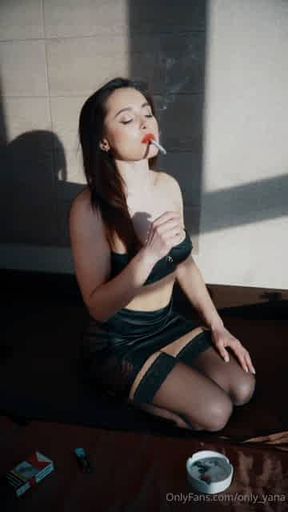 Pretty girl enjoying her cigarette facing the sun wearing leather
