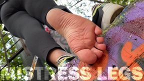Pink socks and natural rough wrinkled soles above you outdoor