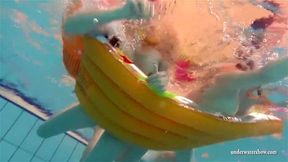 Mia and Petra undress eachother in the swimmingpool