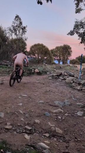 Barefoot man riding bicycle