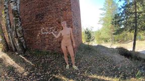 Nude girl came to an old red brick building