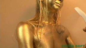 A beautiful woman is exercising with full body gold