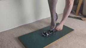 Giantess Lily Kink toy car crush of a black Plymouth GTX with high heels left view