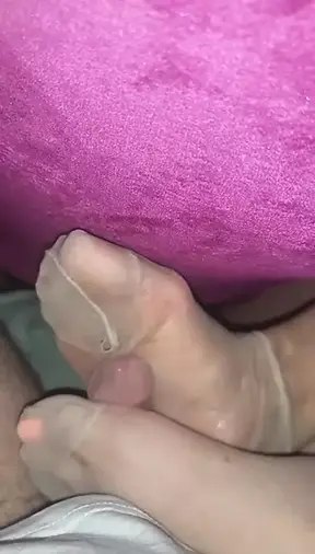 Footjob in ripped nylonsocks