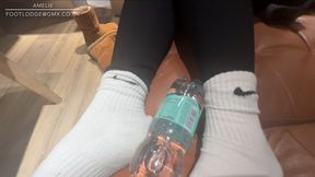 Ugg boots, black leggings and white Nike socks ,playing with a bottle with my feet