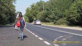 Skinny brunette hitchhiking  with her bladder full