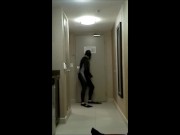 wearing wetsuit and fins shoot a quick load at open hotel door