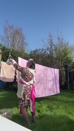In maid gardener outfit to hang the laundry
