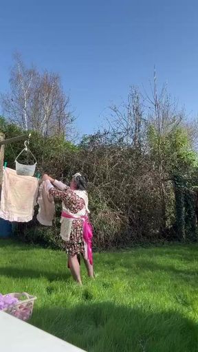 In maid gardener outfit to hang the laundry