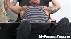 Huge muscular dude endures a feet tickling torment