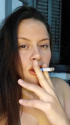 Dominant Latina smokes while controlling her submissive