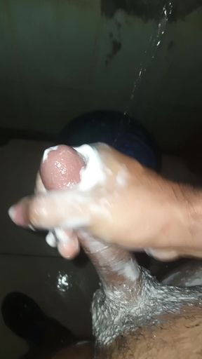 Guy in the shower soaps and masturbates by taking milk out of penis