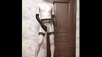 Crossdresser in a cage fucks with a dildo and poses naked