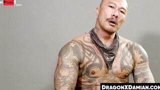 Buffed Damian Dragon stuffs his ass with a dildo while jerking himself