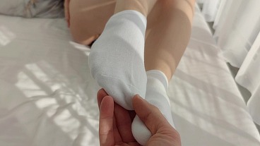 Sockjob from a hottest girl with an anal plug in her round ass