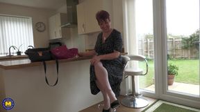 Busty redheaded GILF brings some new toys into her bedroom.