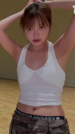 K-pop fan with a belly button piercing shows off her toned body