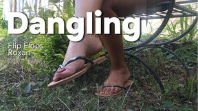 Flip-flops swing back and forth as they dangle from Roxan's feet (3)