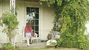 Playful and awkward tattooed femme plays with a toy while her partner joins in