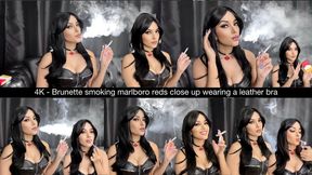 4K - Brunette smoking marlboro reds close up wearing a leather bra