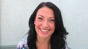 Attractive brunette babe Kelly Diamond smiles on camera showing off her body