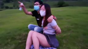chinese couple play bondage in a park