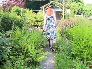 Breasty honey Red XXX fingers herself in the garden