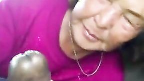 ”Asian Old Woman Sucks Ebony Meat In The Car”