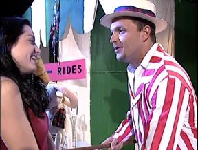 Booth sleight-of-hand performer from trade fair tepmts pretty young brunette