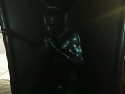 Slave encased in latex vacuum tower