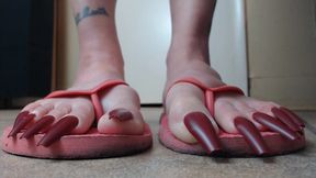 Long red toenails pink flipflops